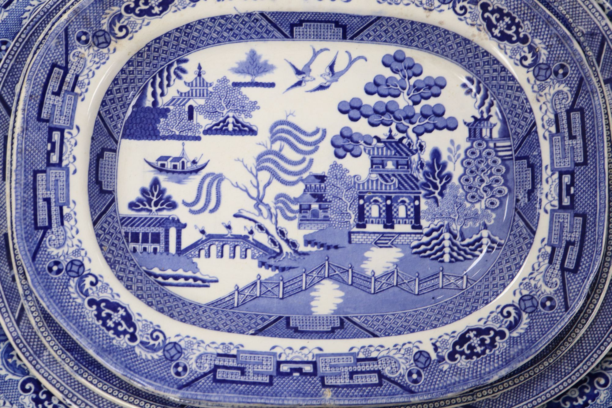 A 19th century transfer-printed large blue and white platter and seven similar smaller platters